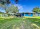 Expansive backyard featuring a covered patio, perfect for outdoor entertaining and enjoying the serene surroundings at 91 High St, Winter Haven, FL 33880