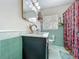 Charming bathroom featuring colorful shower curtain, swan faucet, and bright tile at 91 High St, Winter Haven, FL 33880