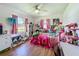 Bedroom featuring vinyl floors, overhead ceiling fan, and pink curtains at 91 High St, Winter Haven, FL 33880