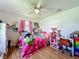 Cozy bedroom featuring a ceiling fan, wood floors, and pink accents at 91 High St, Winter Haven, FL 33880