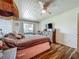 Bedroom featuring wood-look floors, bright lighting, and comfortable decor at 91 High St, Winter Haven, FL 33880