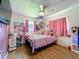 Charming bedroom with pink accents, laminate floors, and lots of natural light at 91 High St, Winter Haven, FL 33880