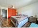 Bedroom featuring wood-look floors, closet, and orange curtain at 91 High St, Winter Haven, FL 33880