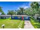 Beautiful blue home with a well-maintained lawn and inviting pathway leading to a vibrant red front door at 91 High St, Winter Haven, FL 33880