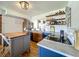 A modern kitchen features a center island, stainless steel appliances, and open shelving for a clean design at 91 High St, Winter Haven, FL 33880