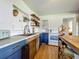 Modern kitchen showcasing stainless steel appliances, custom wood cabinetry and open shelving for storage and display at 91 High St, Winter Haven, FL 33880