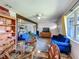 Bright living room with stylish blue sofas, area rug, and views to adjacent kitchen area at 91 High St, Winter Haven, FL 33880
