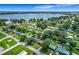 Aerial view of the neighborhood with the lake in the distance and tree lined streets at 91 High St, Winter Haven, FL 33880