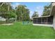 Backyard with an enclosed patio space and a second stone patio with Adirondack chairs for outdoor enjoyment at 941 Grey Oak Ct, Orlando, FL 32809