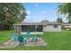 Well-kept backyard and patio area with four chairs and screened-in porch, perfect for outdoor relaxation at 941 Grey Oak Ct, Orlando, FL 32809