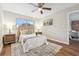Bright bedroom with wood-look flooring, a ceiling fan, and matching nightstands at 941 Grey Oak Ct, Orlando, FL 32809