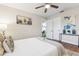 Comfortable bedroom with ceiling fan, stylish decor, and white and grey bedding at 941 Grey Oak Ct, Orlando, FL 32809