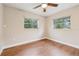 Bright bedroom with laminate floors, a ceiling fan, and natural light from windows at 941 Grey Oak Ct, Orlando, FL 32809