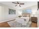 Cozy bedroom with a ceiling fan, wood-look flooring, and a neutral color scheme at 941 Grey Oak Ct, Orlando, FL 32809