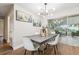 Contemporary dining room with modern lighting, stylish furniture, and sliding doors to outdoor living area at 941 Grey Oak Ct, Orlando, FL 32809