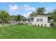 Charming one-story home with a green lawn, complemented by flowering plants and a well-maintained landscape at 941 Grey Oak Ct, Orlando, FL 32809