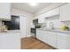 Well-lit kitchen with white cabinets, stainless steel appliances, and marble countertops at 941 Grey Oak Ct, Orlando, FL 32809