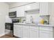 Bright kitchen with white cabinets, stainless steel appliances, and marble countertops at 941 Grey Oak Ct, Orlando, FL 32809