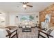 Inviting living room boasting a brick wall, modern decor, a cozy sofa, and stylish seating at 941 Grey Oak Ct, Orlando, FL 32809