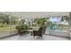 Screened-in patio featuring wicker furniture including a sofa and chair with a glass-topped table on a concrete floor at 941 Grey Oak Ct, Orlando, FL 32809