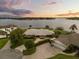 Stunning lakefront home with lush landscaping, mature trees, and private boat dock offering serene water views at 4318 Waterfront Pkwy, Orlando, FL 32806