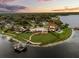 Expansive waterfront estate featuring manicured lawns, mature trees, a private dock, and peaceful lake views at 4318 Waterfront Pkwy, Orlando, FL 32806