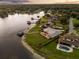 Aerial view of a waterfront property with a pool and manicured lawn, surrounded by lush trees and lake access at 4318 Waterfront Pkwy, Orlando, FL 32806