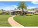 Sprawling backyard with a lush lawn and a charming brick pathway leading to the home at 4318 Waterfront Pkwy, Orlando, FL 32806