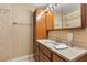 Bathroom with a large vanity, mirror, and a shower with tile surround at 4318 Waterfront Pkwy, Orlando, FL 32806