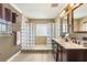 Well-lit bathroom featuring a glass block shower, double vanity, and tile floors for a modern touch at 4318 Waterfront Pkwy, Orlando, FL 32806