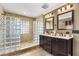 Elegant bathroom with a double vanity, shower with glass blocks, and tiled floors for a spa-like retreat at 4318 Waterfront Pkwy, Orlando, FL 32806