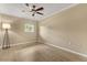 Bedroom featuring light wood floors, a window, and neutral-colored walls at 4318 Waterfront Pkwy, Orlando, FL 32806