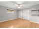 Bedroom featuring wood floors, neutral paint, and a double closet for storage at 4318 Waterfront Pkwy, Orlando, FL 32806