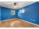 Bright bedroom featuring blue walls, wood floors, and two windows for natural light at 4318 Waterfront Pkwy, Orlando, FL 32806
