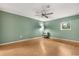 Minimalist bedroom with wood floors, a ceiling fan, and a large window at 4318 Waterfront Pkwy, Orlando, FL 32806