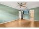 Spacious bedroom featuring wood floors, a ceiling fan, and an en-suite bathroom at 4318 Waterfront Pkwy, Orlando, FL 32806