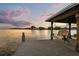 Private boat dock features a wooden swing and overlooks calm lake waters with a picturesque landscape at 4318 Waterfront Pkwy, Orlando, FL 32806