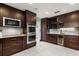 Gourmet kitchen features stainless steel appliances, custom cabinetry, a wine rack, and a built-in oven at 4318 Waterfront Pkwy, Orlando, FL 32806