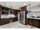 Elegant kitchen with stainless steel refrigerator, wine storage, and marble tile floor at 4318 Waterfront Pkwy, Orlando, FL 32806