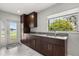 Spacious kitchen with dark cabinets, stainless steel sink and backyard access at 4318 Waterfront Pkwy, Orlando, FL 32806