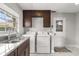 Bright laundry room with full-size washer and dryer, sink and tile floors at 4318 Waterfront Pkwy, Orlando, FL 32806