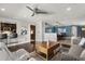 Open concept living area with bar, ceiling fan, and seamless transition to other living spaces at 4318 Waterfront Pkwy, Orlando, FL 32806