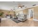 Inviting living room featuring tile floors, a comfortable seating area, and multiple ceiling fans at 4318 Waterfront Pkwy, Orlando, FL 32806
