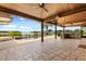 Covered outdoor patio with a built-in grill, ceiling fans, and a stunning lake view with a pool at 4318 Waterfront Pkwy, Orlando, FL 32806