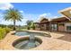 Beautiful pool area with a spa and a covered patio area with a kitchen for outdoor enjoyment at 4318 Waterfront Pkwy, Orlando, FL 32806
