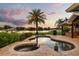 Gorgeous outdoor living space with a custom pool, spa, and lush tropical landscaping overlooking the lake at 4318 Waterfront Pkwy, Orlando, FL 32806