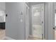 Bathroom with gray walls, marble tile floors, and tiled shower/tub combination at 1066 Swanson Dr, Deltona, FL 32738