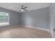 Bedroom with new flooring, a ceiling fan, a large window with natural light, and closet at 1066 Swanson Dr, Deltona, FL 32738