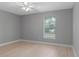 Neutral bedroom with a window and ceiling fan at 1066 Swanson Dr, Deltona, FL 32738