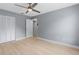 Bright bedroom featuring light wood floors, a ceiling fan, and a closet at 1066 Swanson Dr, Deltona, FL 32738